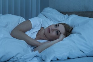 Young Woman Suffering From Insomnia Lying In Her Bed